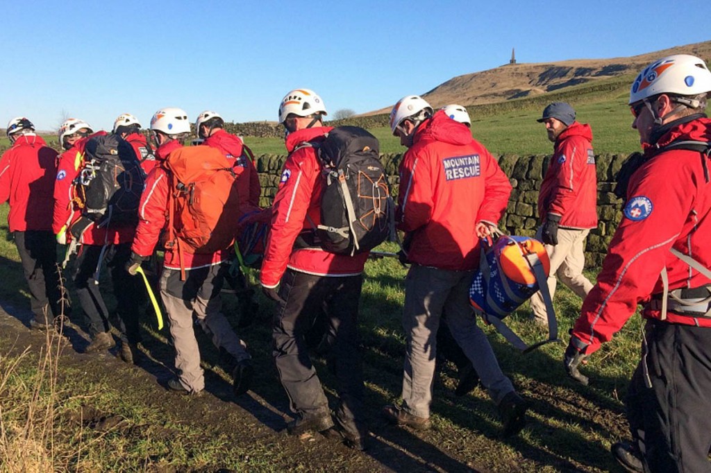 Rescuers stretcher the injured walker from the site near Stoodley Pike. Photo: Calder Valley SRT