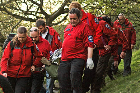 The team stretchers the injured youth from the scene. Photo: Calder Valley SRT The team stretchers the injured youth from the scene. Photo: Calder Valley MRT