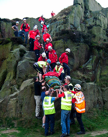 The woman is lowered on a stretcher from rocks near the Cow and Calf. Photo: Calder Valley SRT The woman is lowered on a stretcher from rocks near the Cow and Calf. Photo: Calder Valley SRT