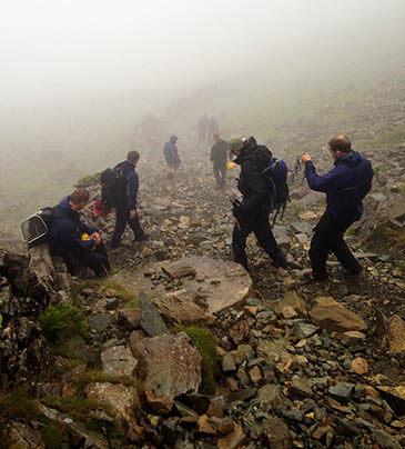 Cockermouth team members help the stranded walkers down from High Crag. Photo: Cockermouth MRT Cockermouth team members help the stranded walkers down from High Crag. Photo: Cockermouth MRT