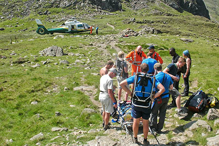 Rescuers prepare to stretcher the injured boy to the air ambulance. Photo: Cockermouth MRT Rescuers prepare to stretcher the injured boy to the air ambulance. Photo: Cockermouth MRT