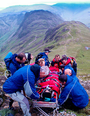 Rescuers with the injured walker on High Crag. Photo: Cockermouth MRT Rescuers with the injured walker on High Crag. Photo: Cockermouth MRT
