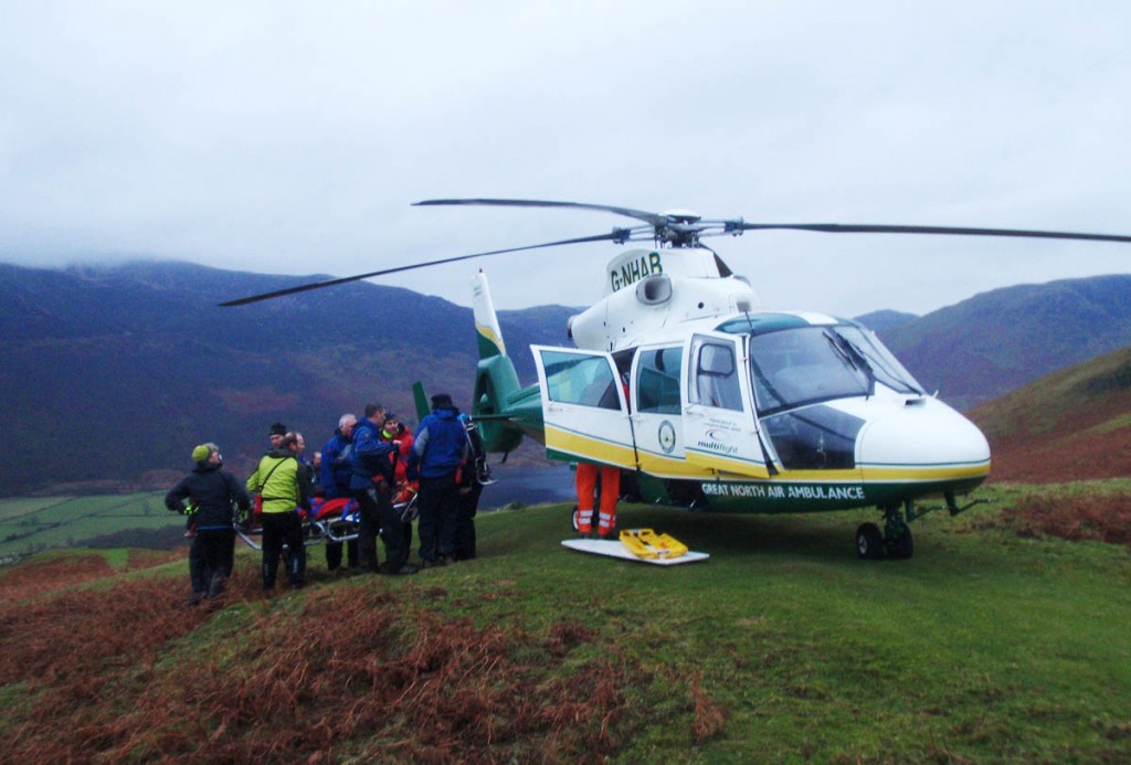 Rescue team members place the injured walker in the air ambulance. Photo: Cockermouth MRT