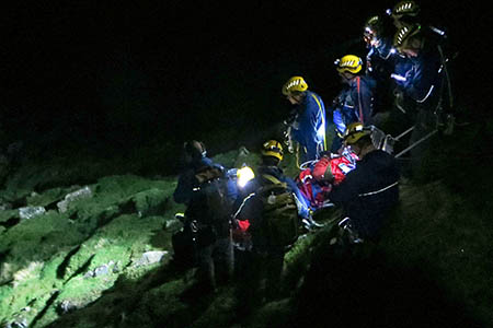 Rescuers move the injured man below the cloud level. Photo: Cockermouth MRT Rescuers move the injured man below the cloud level. Photo: Cockermouth MRT
