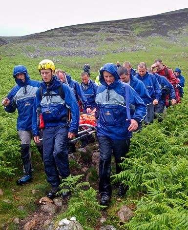 The Cockermouth team carries the injured walker from the fell. Photo: Cockermouth MRT The Cockermouth team carries the injured walker from the fell. Photo: Cockermouth MRT