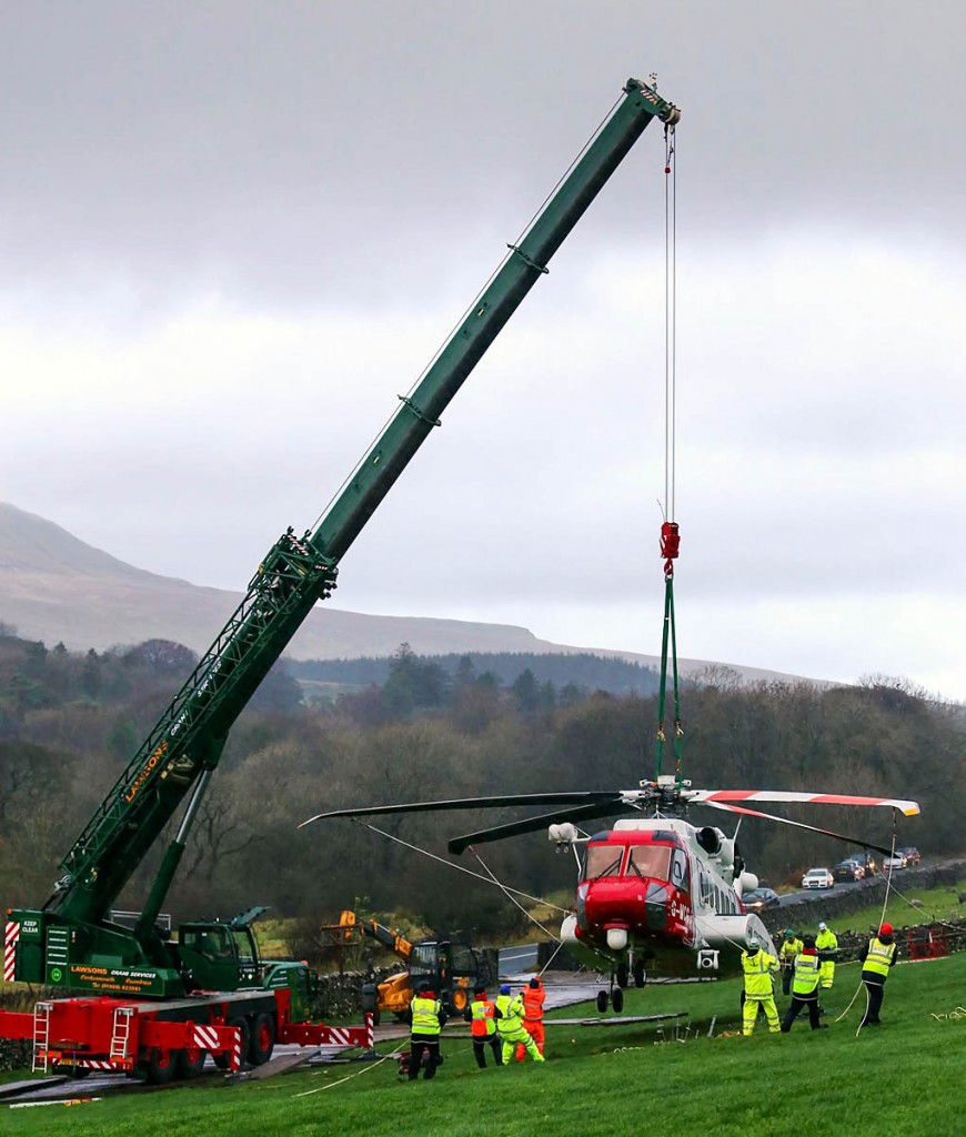 The Coastguard helicopter is craned on to a stable platform. Photo: CRO The Coastguard helicopter is craned on to a stable platform. Photo: CRO