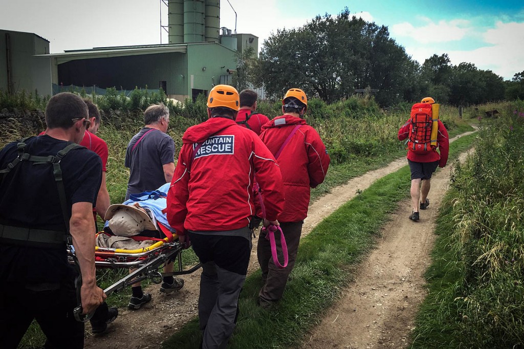 Rescuers stretcher the injured climber from the crag. Photo: Derby MRT