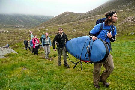 Club members carry the sailboard and other gear up the glen Club members carry the sailboard and other gear up the glen