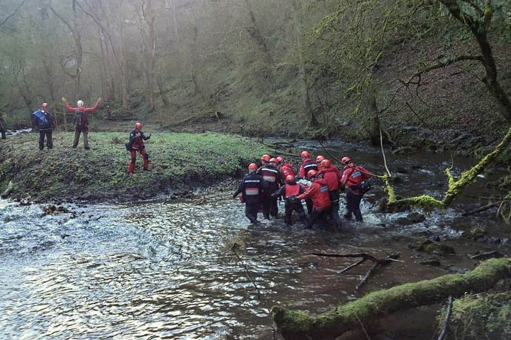 Rescuers stretcher the injured man to the island during the day's first incident. Photo: Edale MRT