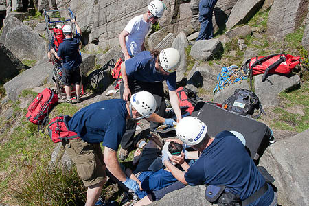 Edale team members treat the fallen climber at Burbage Edale team members treat the fallen climber at Burbage