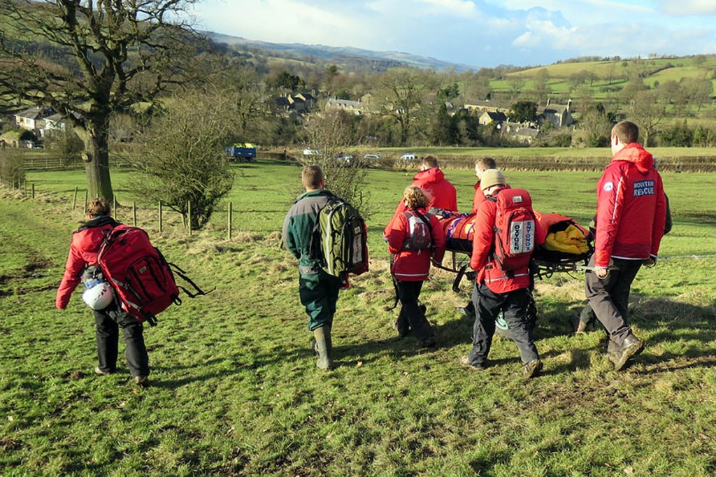 Rescuers stretcher the injured walker from the hillside. Photo: Edale MRT Rescuers stretcher the injured walker from the hillside. Photo: Edale MRT