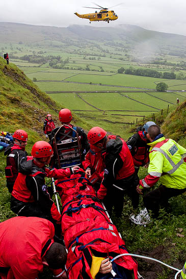 Rescuers treat the walker in the gully. Photo: Edale MRT Rescuers treat the walker in the gully. Photo: Edale MRT