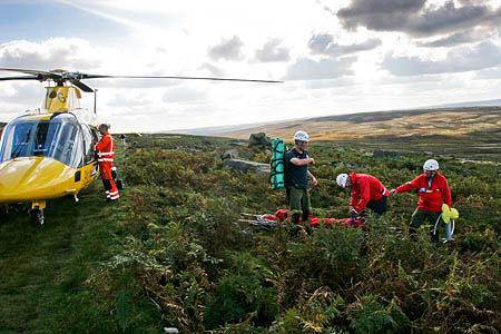 Edale team members with the air ambulance during the rescue at Stanage End. Photo: Edale MRT Edale team members with the air ambulance during the rescue at Stanage End. Photo: Edale MRT