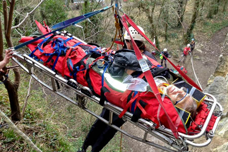 Rescuers lower the climber on the stretcher Rescuers lower the climber on the stretcher