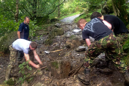 Volunteers repair a path near Aria Force Volunteers repair a path near Aria Force