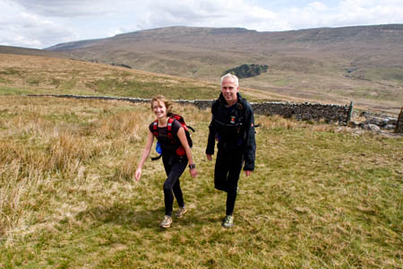Two Fellsman competitors climb Gragareth, with Whernside behind them Two Fellsman competitors climb Gragareth, with Whernside behind them