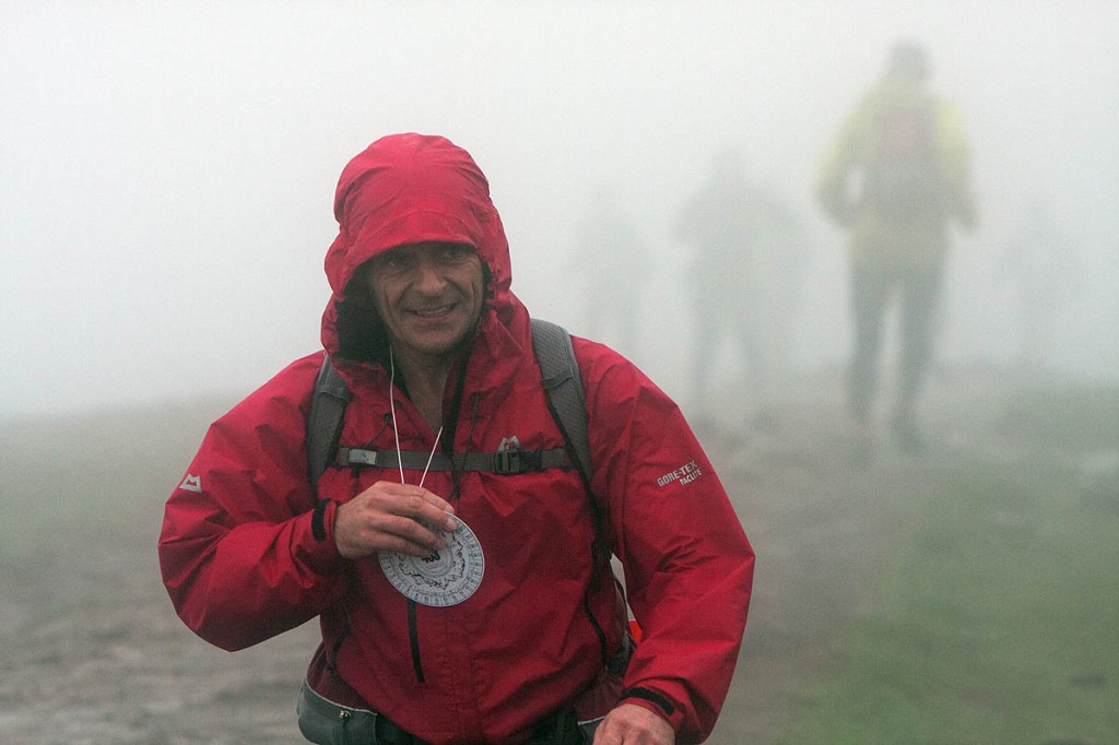 A Fellsman competitor arrives at Whernside summit