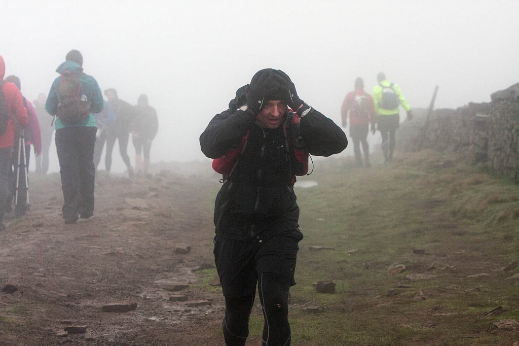 Hang on to your hat: a Fellsman competitor arrives at the Whernside summit