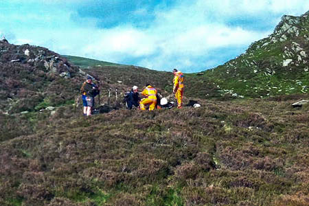 Great North Air Ambulance crew members treat the injured walker on Fleetwith Pike. Photo: GNAA Great North Air Ambulance crew members treat the injured walker on Fleetwith Pike. Photo: GNAA