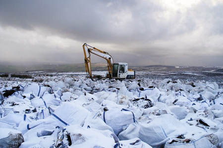 Bags of heather brash on Glossop Low, ready to be airlifted Bags of heather brash on Glossop Low, ready to be airlifted