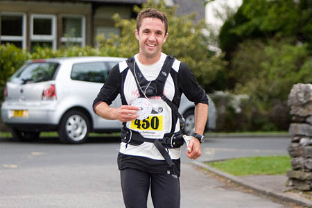 A smlie on the face of Jez Bragg as he arrives at the Threshfield finish in record time A smlie on the face of Jez Bragg as he arrives at the Threshfield finish in record time