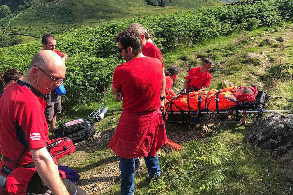 Rescuers with the injured woman on the fell. Photo: Keswick MRT