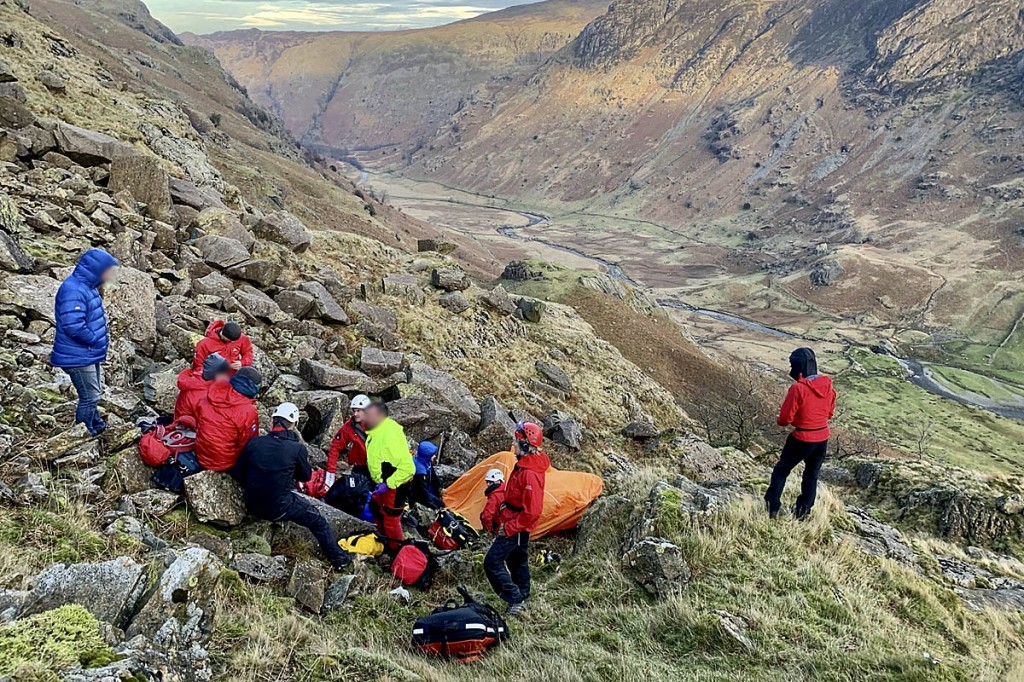 Rescuers with the casualty and the group in Langstrath. Photo: Keswick MRT Rescuers with the casualty and the group in Langstrath. Photo: Keswick MRT