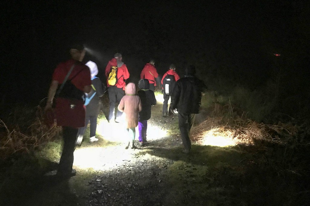 Rescuers accompany the family to safety. Photo: Keswick MRT Rescuers accompany the family to safety. Photo: Keswick MRT