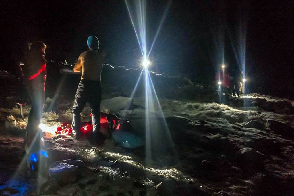 Rescuers bring stranded walkers to safety. Photo: Keswick MRT