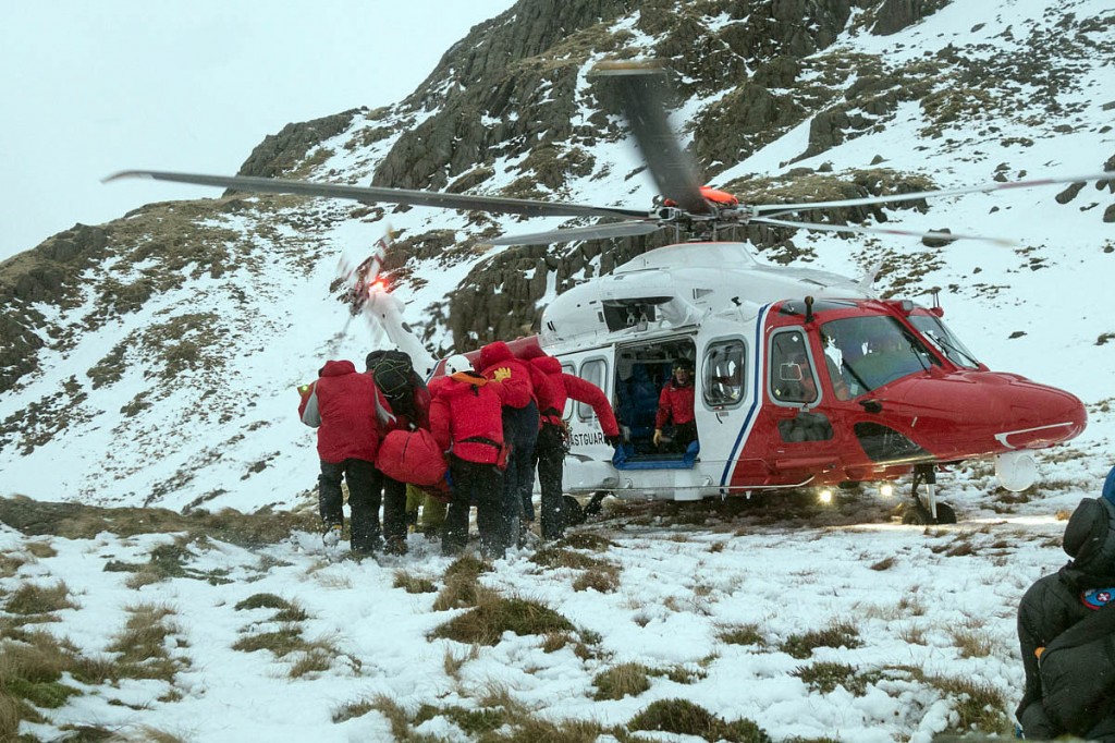 Team members carry the casualty to the helicopter. Photo: Keswick MRT Team members carry the casualty to the helicopter. Photo: Keswick MRT