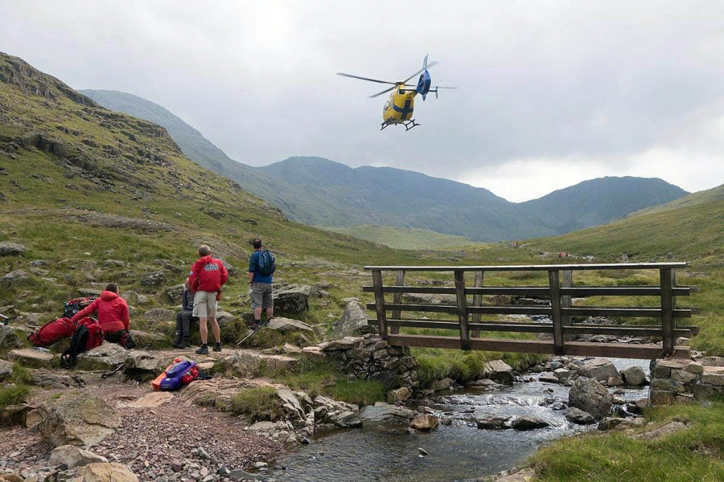 Team members and the North West Air Ambulance at the rescue site. Photo: Keswick MRT Team members and the North West Air Ambulance at the rescue site. Photo: Keswick MRT