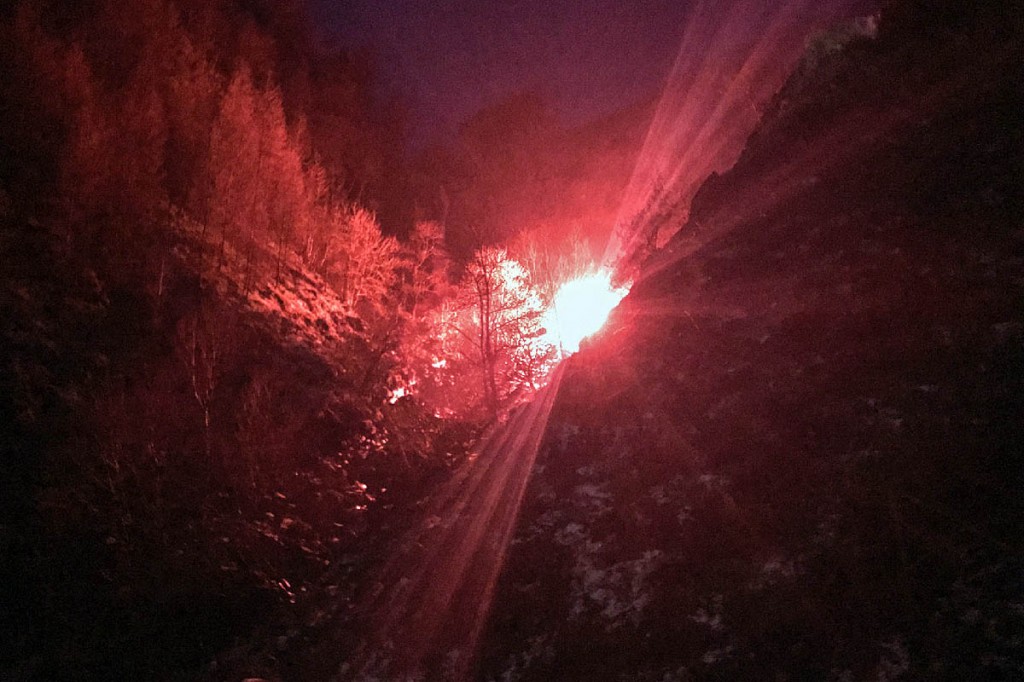 Rescuers set off a red flare to guide the helicopter to the incident site. Photo: Keswick MRT Rescuers set off a red flare to guide the helicopter to the incident site. Photo: Keswick MRT
