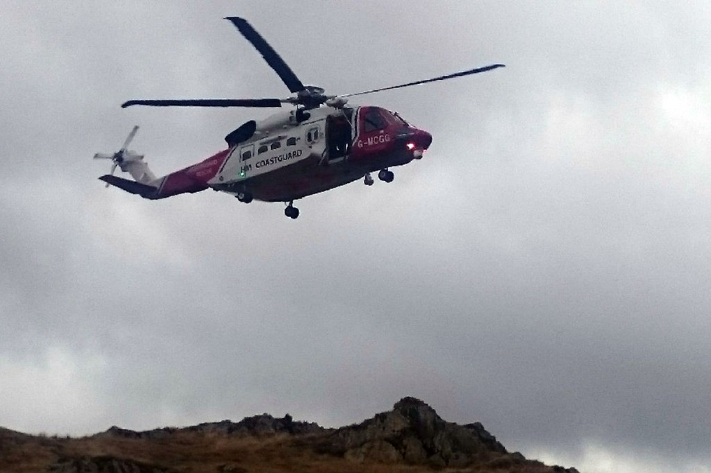 The Coastguard helicopter approaches to transfer the injured man. Photo: Keswick MRT