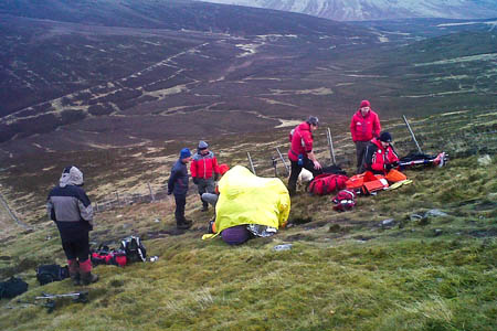 Team members at the scene treat the walker under a bivvy shelter. Photo: Keswick MRT Team members at the scene treat the walker under a bivvy shelter. Photo: Keswick MRT