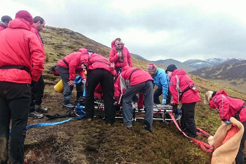Keswick team members prepare to stretcher the injured walker from the fell. Photo: Keswick MRT Keswick team members prepare to stretcher the injured walker from the fell. Photo: Keswick MRT