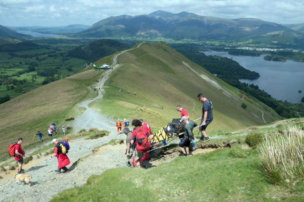 Team members stretcher the injured walker down to the helicopter. Photo: Stuart Holmes/Keswick MRT