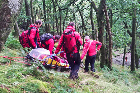 Keswick rescuers stretcher the injured walker from the scene. Photo: Keswick MRT Keswick rescuers stretcher the injured walker from the scene. Photo: Keswick MRT