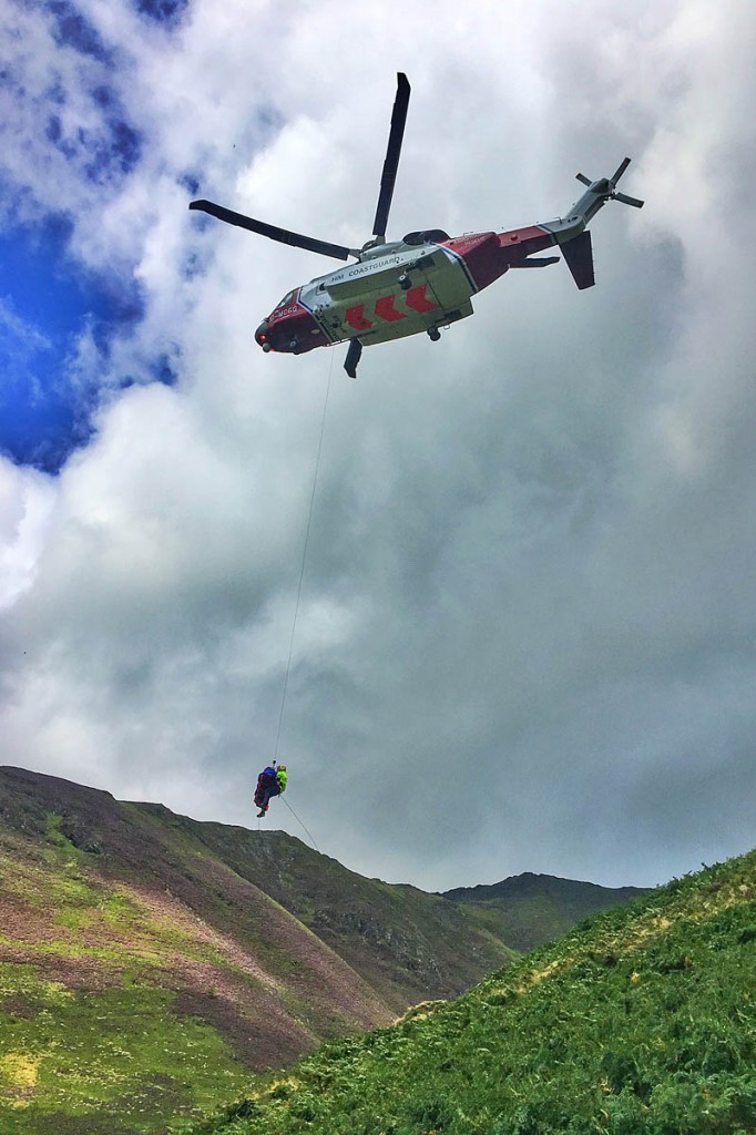 The injured man is winched into the Coastguard helicopter. Photo: Keswick MRT The injured man is winched into the Coastguard helicopter. Photo: Keswick MRT