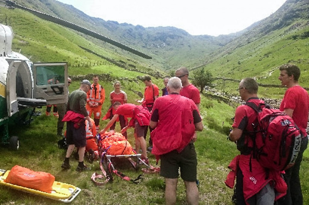 Rescuers prepare to put the walker in the air ambulance. Photo: Keswick MRT Rescuers prepare to put the walker in the air ambulance. Photo: Keswick MRT