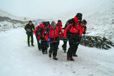 Rescuers stretcher one of the injured people from the scene. Photo: Langdale Ambleside MRT