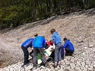 Edale Mountain Rescue Team members with the casualty at the reservoir site Edale Mountain Rescue Team members with the casualty at the reservoir site