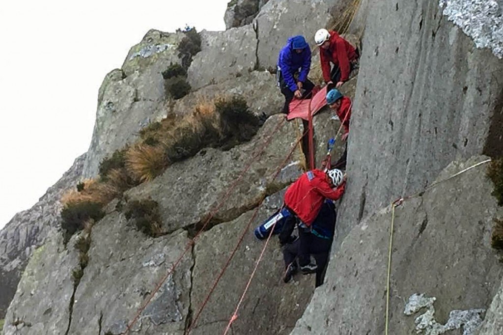 Rescuers work to free the climber from the crack. Photo: Llanberis MRT