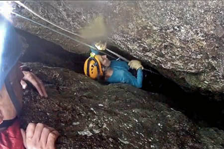 The second rescuer is lowered down the tight crevice. Photo: Llanberis MRT The second rescuer is lowered down the tight crevice. Photo: Llanberis MRT