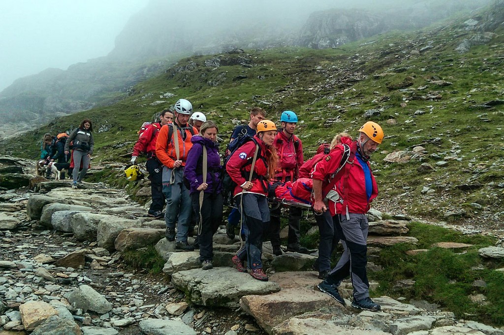 Members of LLMRT carry a stretcher on the Pyg Track on Snowdon. Photo: Rob Booth Members of LLMRT carry a stretcher on the Pyg Track on Snowdon. Photo: Rob Booth