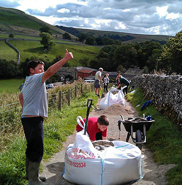 Young rangers at work on the Malham Cove path Young rangers at work on the Malham Cove path