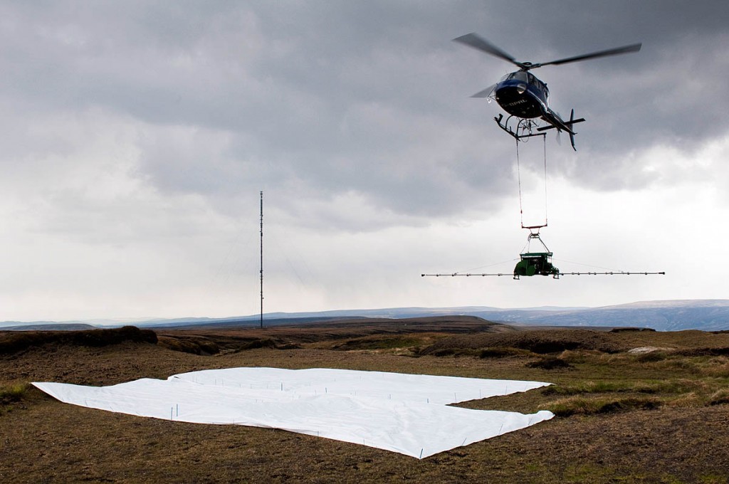 A helicopter drops moss on to the moors as part of the project A helicopter drops moss on to the moors as part of the project
