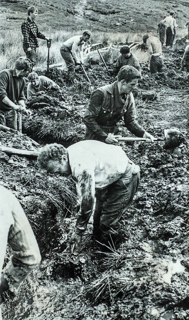 Volunteers dig frantically to divert the beck during the rescue operation. Photo: UWFRA Volunteers dig frantically to divert the beck during the rescue operation. Photo: UWFRA