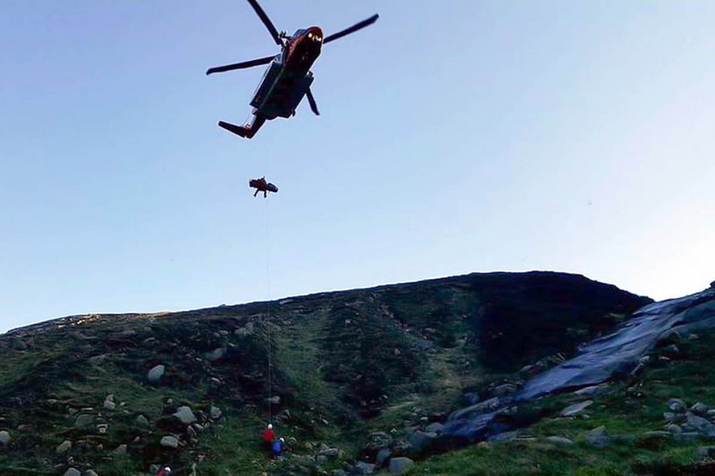 The injured man is winched into the Irish Coastguard helicopter. Photo: Mourne MRT The injured man is winched into the Irish Coastguard helicopter. Photo: Mourne MRT