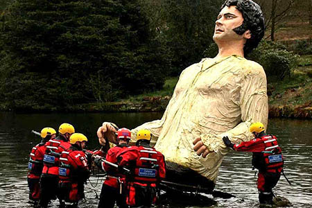 Rescuers remove Mr Darcy from his place in the lake. Photo: Kinder MRT