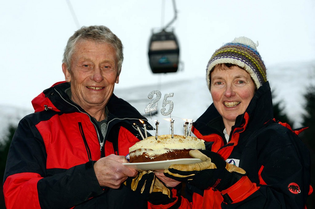 Marian Austin and Ian Sykes celebrate the Nevis Range’s anniversary under the gondola. Photo: Iain Ferguson